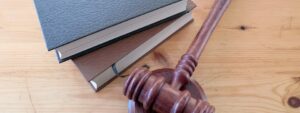 Gavel and legal books on a wood desk.