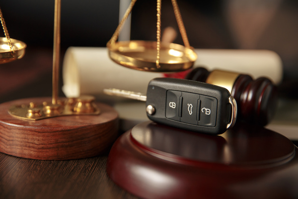 Wooden referee hammer and car keys on the table-top view - DUI charge concept